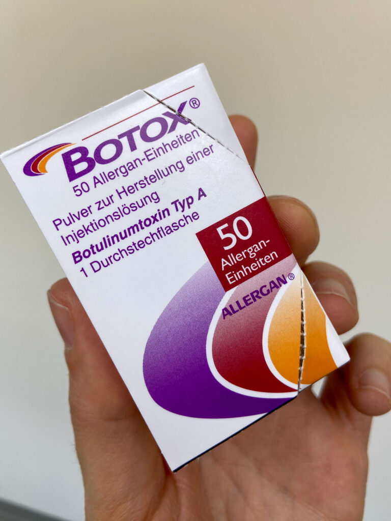 Illustration of a pack of Botox in the hands of Dr. Philip Wimmer