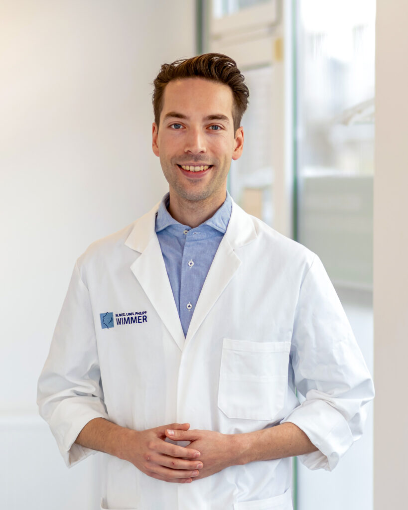 A portrait of ENT Dr. Philipp Wimmer with a doctor's coat.