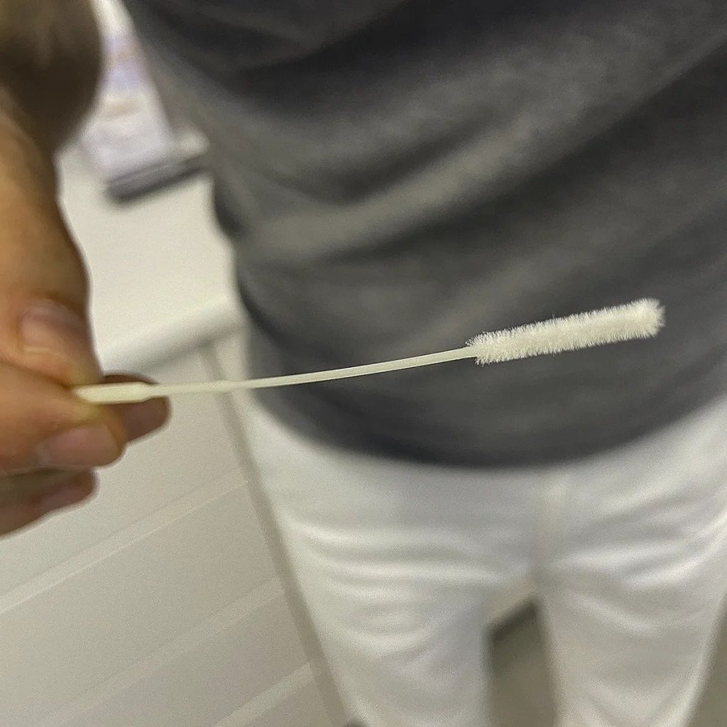 A swab for a rapid streptococcal test in Vienna in the hands of ENT Dr. Philip Wimmer